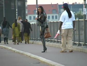 Outside The Mall - Ms von livid visits and gives the locals outside a busy mall a thrill in her skin tight shiny latex leggings, pvc jacket, deep plunging red latex top and ultra-stilettoed boots.